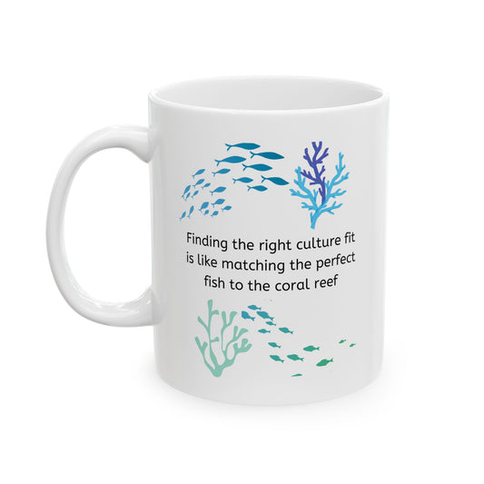 White ceramic corporate jargon coffee mug with coral reef and fish swimming and the talent acquisition phrase, "Finding the right culture fit is like matching the perfect fish to the coral reef"