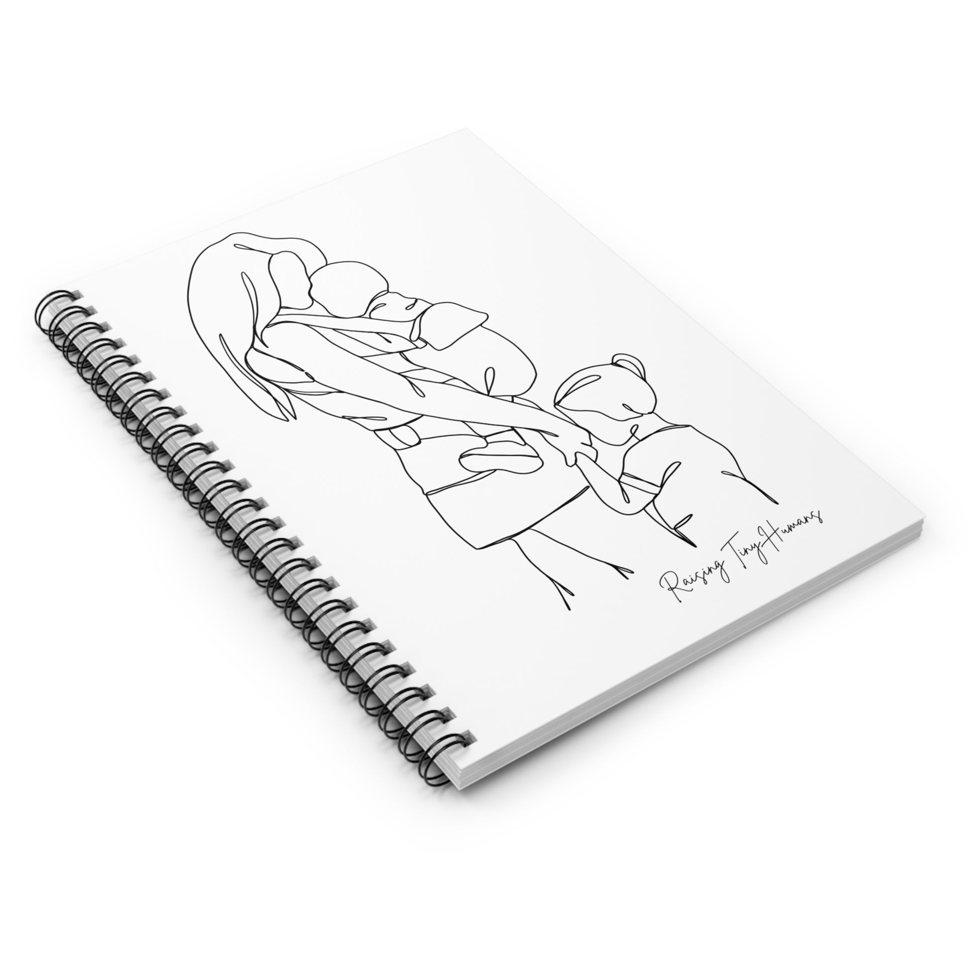 Lying spiral bound notebook, with a cover featuring a simple line drawing of a mother holding a baby in a wearing carrier and holding the hand of a toddler, with the caption "Raising Tiny Humans" featured in handwriting in the bottom right corner of the cover